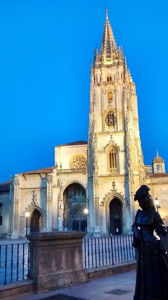 architecture, building exterior, built structure, religion, blue, clear sky, place of worship, spirituality, church, low angle view, cathedral, railing, facade, arch, outdoors, tall - high, old town, history, exterior, city life, day, spire, local landmark, tourism