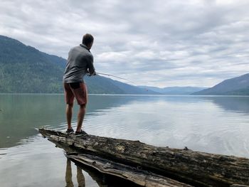 Rear view of man standing at beach