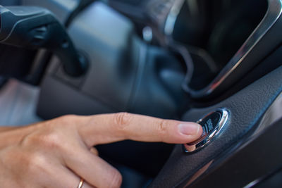 Cropped hand of man washing car