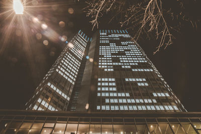 Low angle view of illuminated building against sky at night