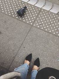 Close-up of woman standing on tiled floor