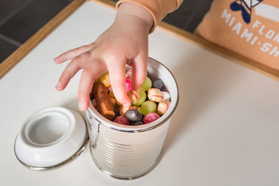 Close-up of hand holding fruit salad