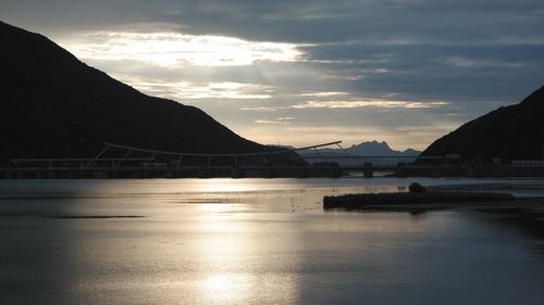 Scenic view of river against cloudy sky