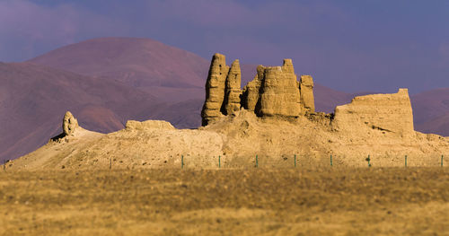 Rock formations on mountain against sky