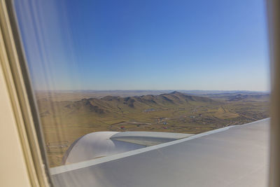 Aerial view of landscape seen through airplane window