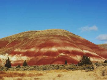 Scenic view of desert against clear blue sky