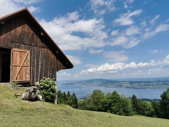 Scenic view of trees and houses against sky