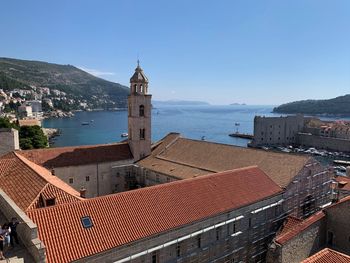 Townscape by sea against sky in town