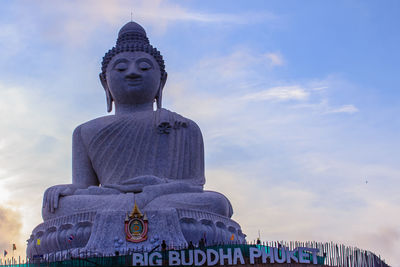 Low angle view of statue against cloudy sky