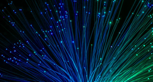 Full frame shot of illuminated fiber optics against black background