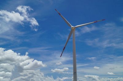 Low angle view of windmill against blue sky