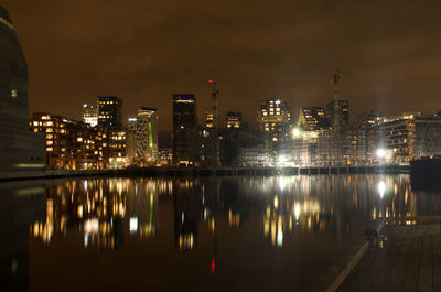 Reflection of illuminated buildings in city at night