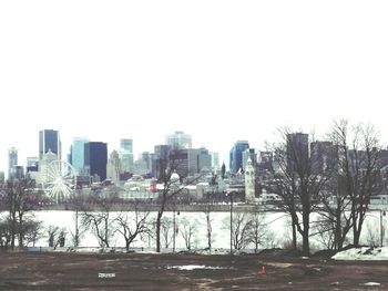 View of buildings in city against clear sky