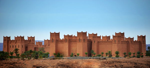 Buildings against clear blue sky