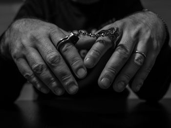 A man handcuffed with small handcuffs
