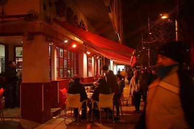 People in illuminated city at night