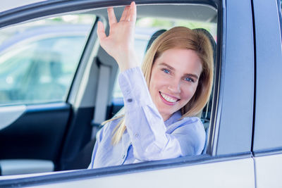 Close-up portrait of woman sitting car