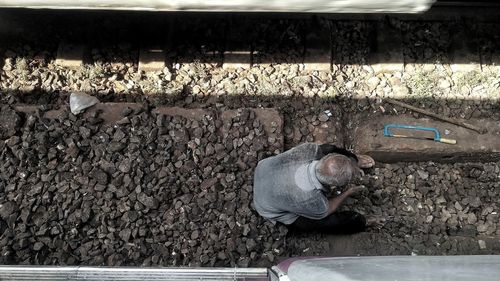 High angle view of man working on wall