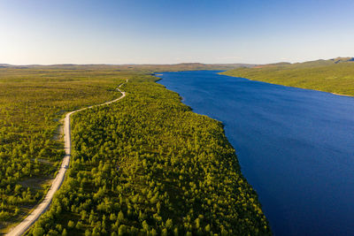 Aerial view of pulmankijärvi lake and sand banks surrounded by forest in nuorgam, finnish lapland