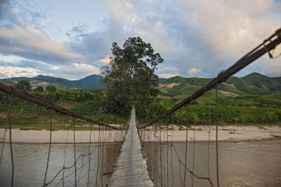 Sketchy suspension footbridge in rural area of vietnam