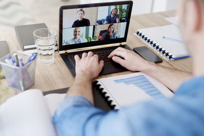 Midsection of man on video conference