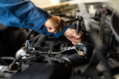 Close-up of man repairing car at workshop