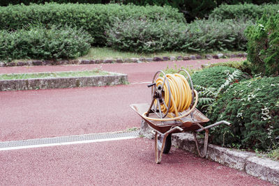 Pipe in wheelbarrow on footpath at park