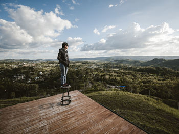 Full length of man standing on landscape against sky