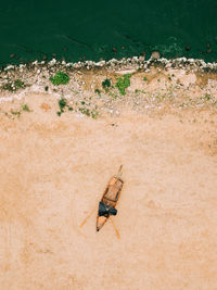 Aerial view of old boat on the sandy shore