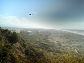 Scenic view of sea against cloudy sky