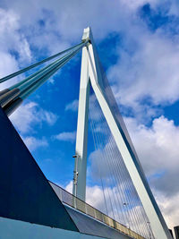 Low angle view of suspension bridge against sky