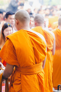 Rear view of people looking at temple