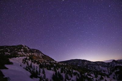 Scenic view of mountains against sky at night