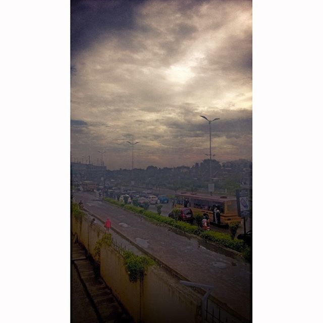 sky, cloud - sky, transfer print, cloudy, building exterior, built structure, architecture, auto post production filter, cloud, overcast, weather, house, nature, transportation, town, city, outdoors, residential structure, mountain, landscape