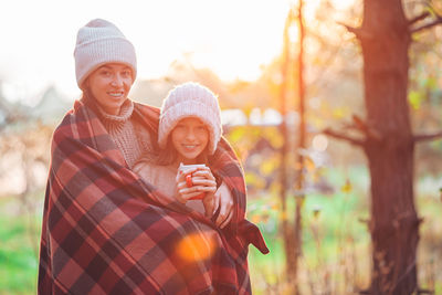 Smiling young woman wearing hat during winter