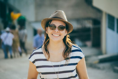 Portrait of smiling young woman wearing sunglasses