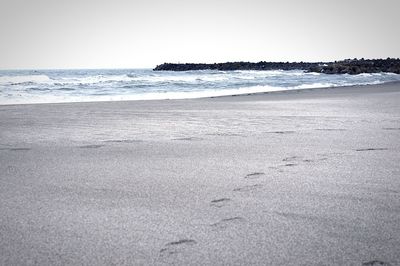 Scenic view of beach against clear sky