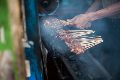 Close-up of man working on metal