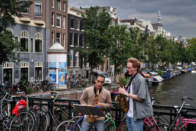 Women standing on bicycle in city