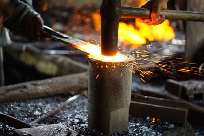 Cropped hands of people working at workshop