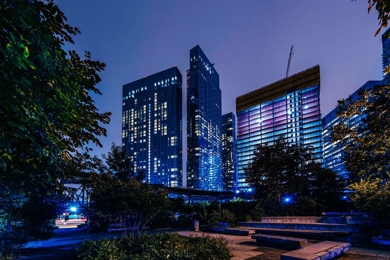 building exterior, architecture, built structure, tree, illuminated, plant, night, city, sky, building, office building exterior, nature, modern, tall - high, skyscraper, no people, clear sky, dusk, lighting equipment, outdoors, cityscape, financial district