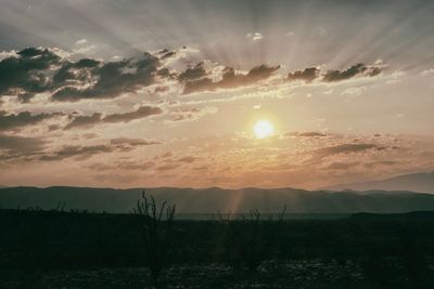 Scenic view of silhouette mountain against sky at sunset