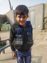 Portrait of boy standing outdoors