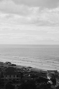 High angle view of townscape by sea against sky