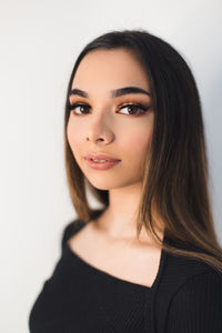 Portrait of a beautiful young woman over white background