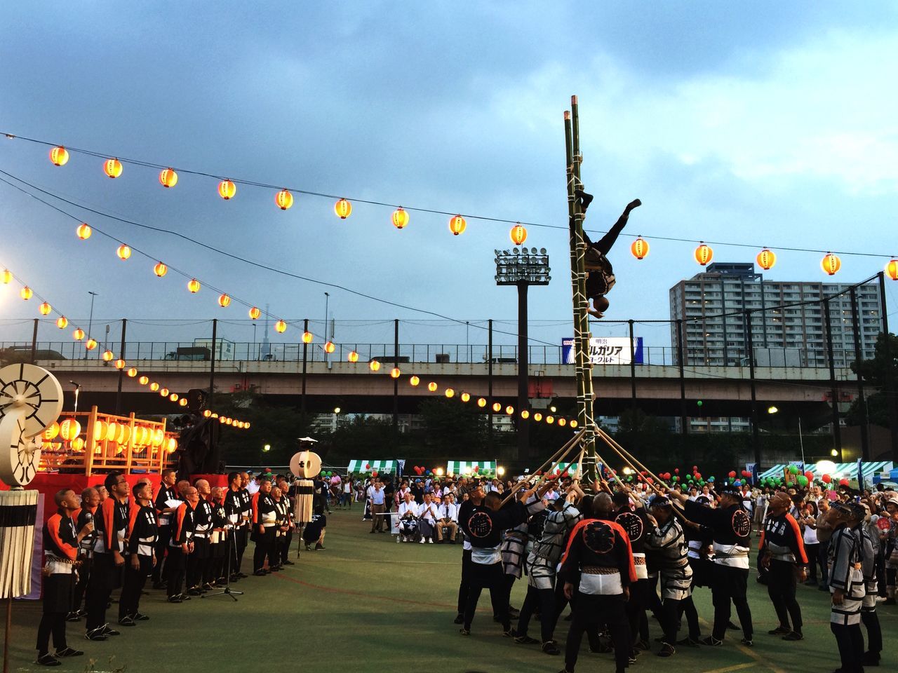 large group of people, sky, men, arts culture and entertainment, person, amusement park, celebration, leisure activity, crowd, lifestyles, cloud - sky, carousel, traditional festival, amusement park ride, multi colored, mixed age range, flag, built structure, cultures