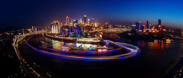 Long exposure shot of buildings in city lit up at night