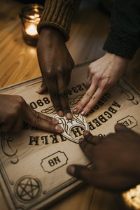Multiracial friends using ouija board
