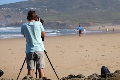 Rear view of friends at beach