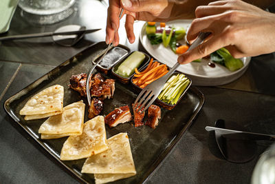 Cropped hands of person preparing food